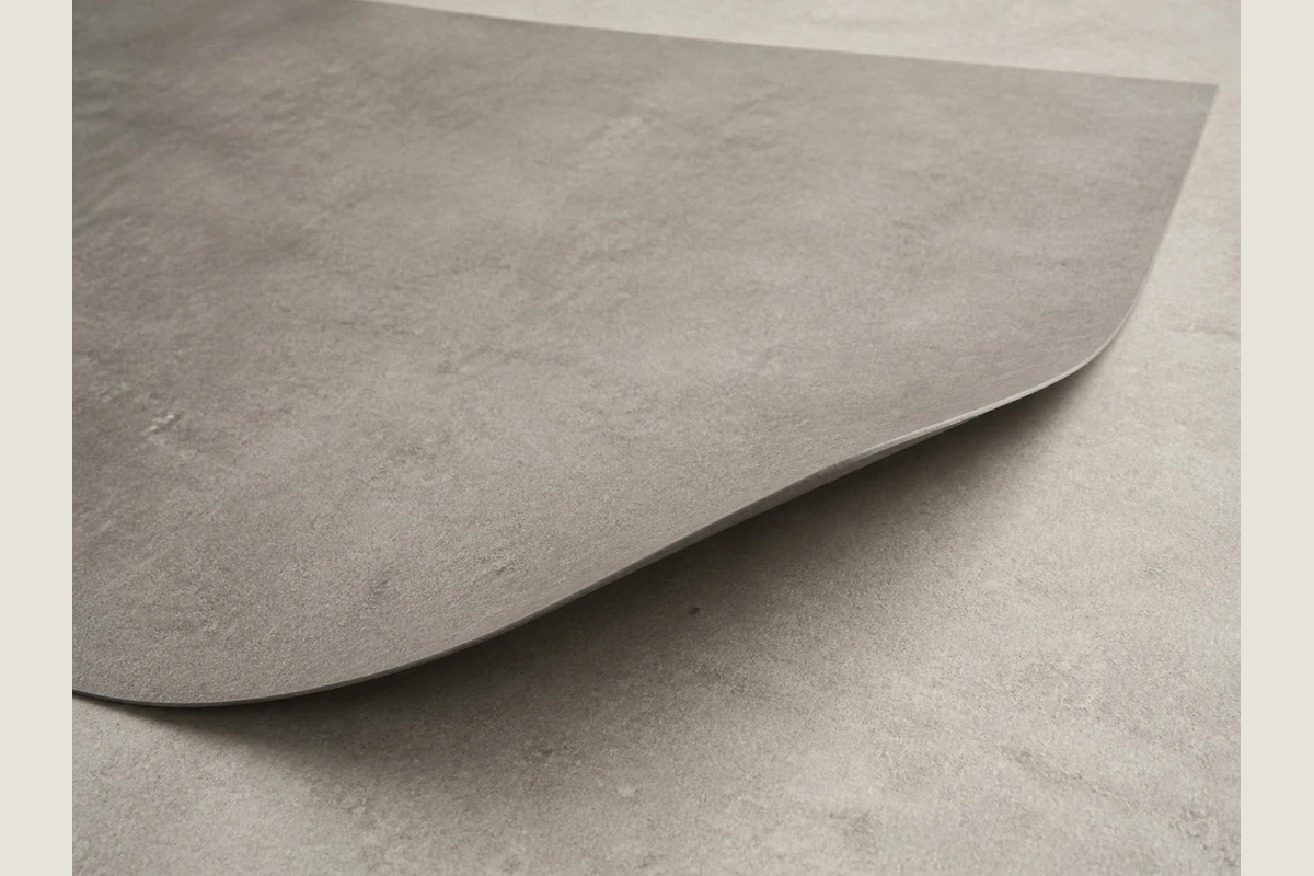 Close view of a grey sheet surface texture and lifted edge